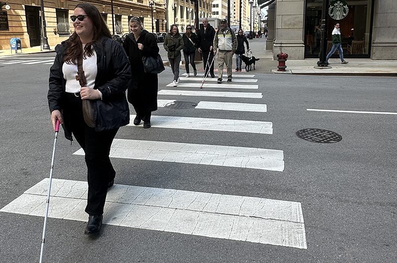 A group of Second Sense clients using their white canes to cross a downtown Chicago street during an O&M training workshop